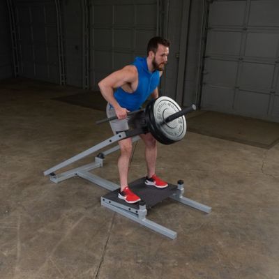 Man Using a T Bar Row Machine in the Gym