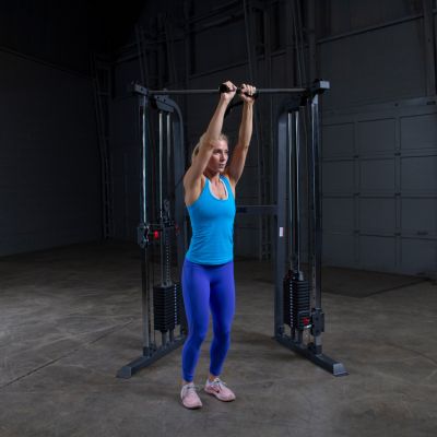 Woman Performing Overhead Cable Tricep Extensions Using Functional Trainer