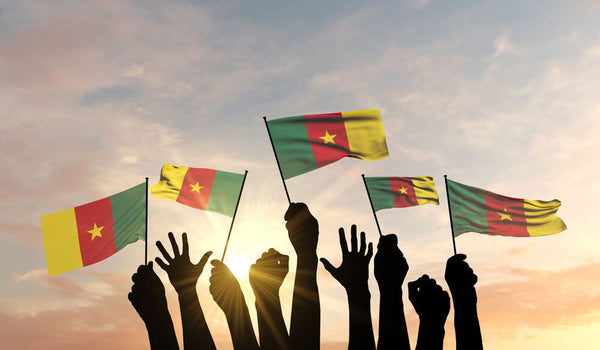 Cameroonians holding up the Cameroon Flag
