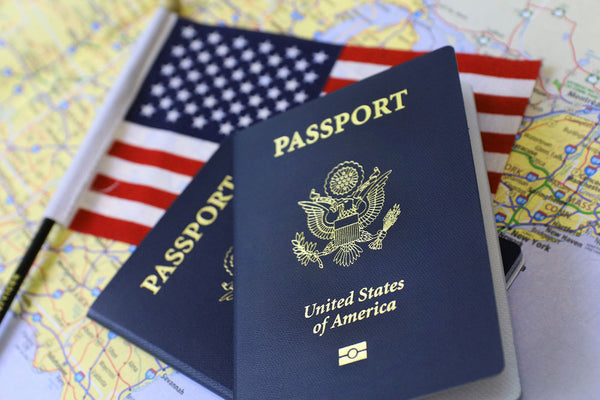 US Passport on top of the United States flag and a map