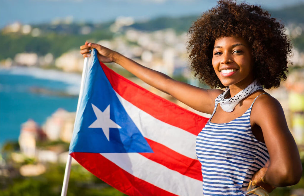 Afro-Latina displaying the Puerto Rican flag.