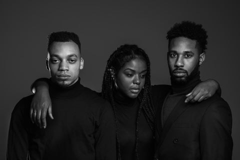 Two Black men and a Black woman wearing Black shirts with Black and White overlay