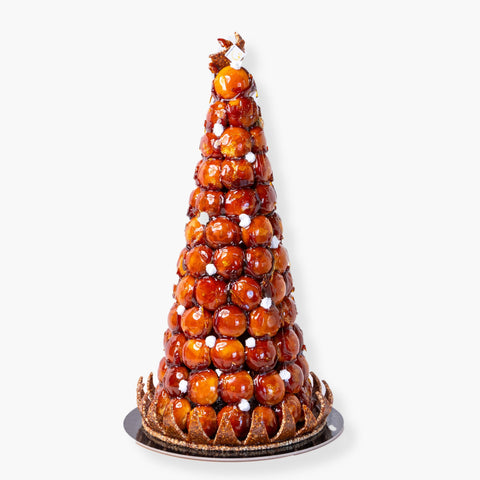 Croquembouche, also known as "pièce montée," is a traditional French dessert with a rich history, made for special occasions & celebrations! The term "croquembouche" is derived from the French words "croquant" (which means crunchy) and "bouche" (which means mouth), referring to the dessert's characteristic crunchy texture.  These towers of cream-filled choux date back to the 18th century and in France one always gets excited to be invited to such special event as it is not a dessert that can be found ready to go in pastry shops.  A pièce montée definitely makes get togethers memorable for everyone!