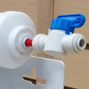 Close-up of a John Guest ball valve shut-off valve connected to the water input of horizontally mounted sediment filter