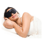 Woman wearing a Sound Oasis Glo to Sleep Mask