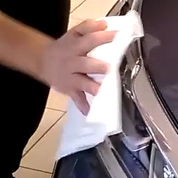 a Wipe and Glow cloth in use polishing a car grill