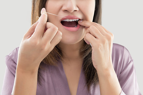 Woman Flossing