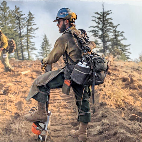 man standing on a fire line wearing JK boots