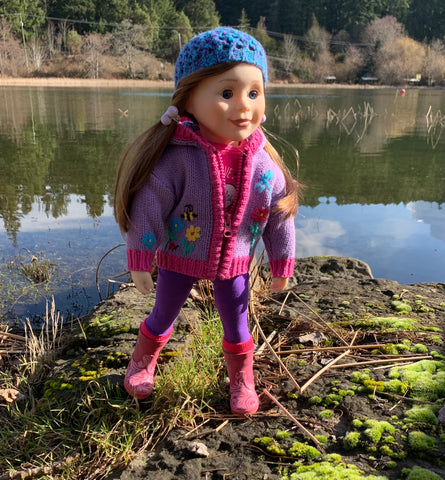 Canadian girl doll dressed in colourful sweater and rain boots goes exploring.