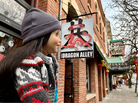 Alexi doll looking a signs in Chinatown Victoria BC