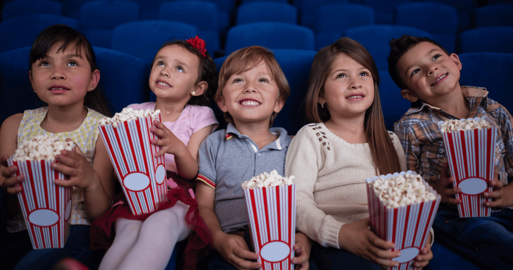 Kids eating popcorn in movie theater