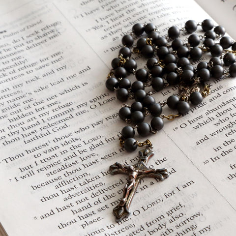 rosary on Bible page