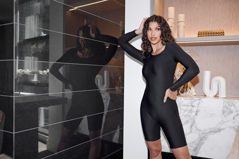 female model in a black estroni bodysuit with full length sleeves