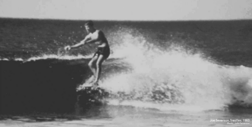 Joe Severson surfing on a wave at Trestles, 1960
