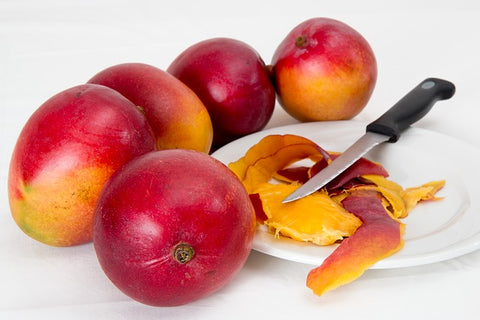myrcene terpenes cutting mango with knife on white plate