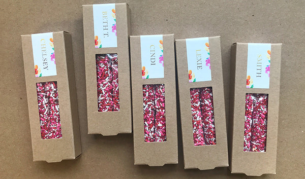 Kraft boxes of two pretzels each with red, pink and white sprinkles and personalized custom design