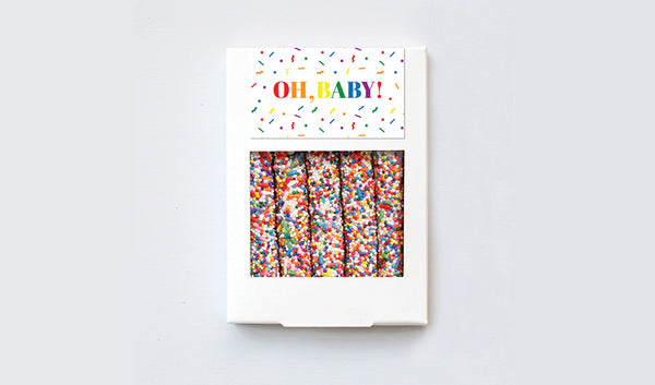 White box of five pretzels with rainbow sprinkles and gender neutral baby customized design