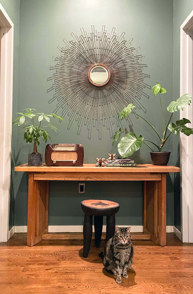 light wood hallway table with african boho styling and cat