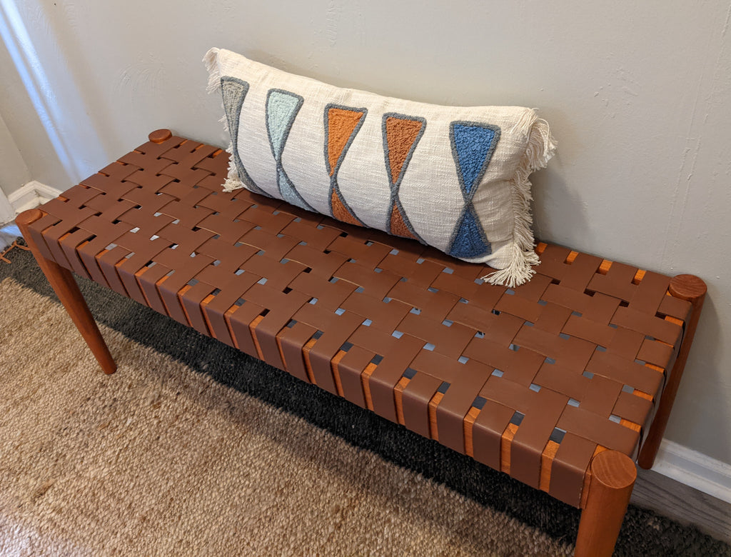 leather strap bench with cream and blue modern lumbar pillow