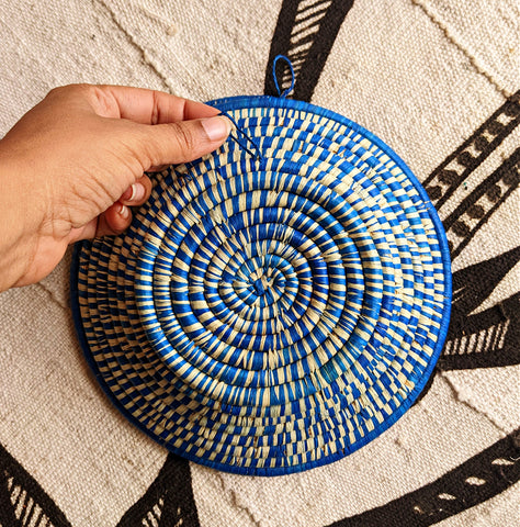 african baskets made with a loop to hang on the wall