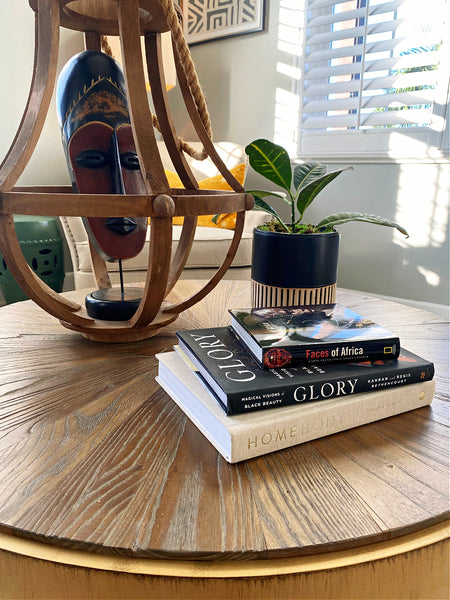 coffee table decorated with books and african art