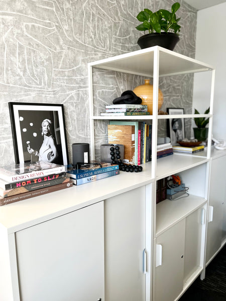 office shelf styling with black art