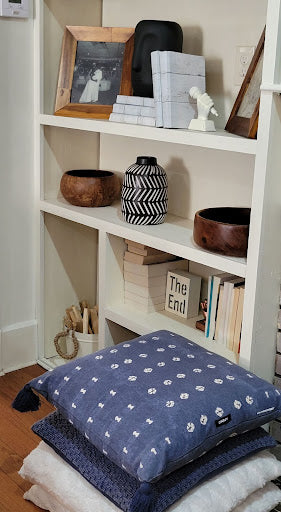 minimalist bookshelf styling with indigo cushions