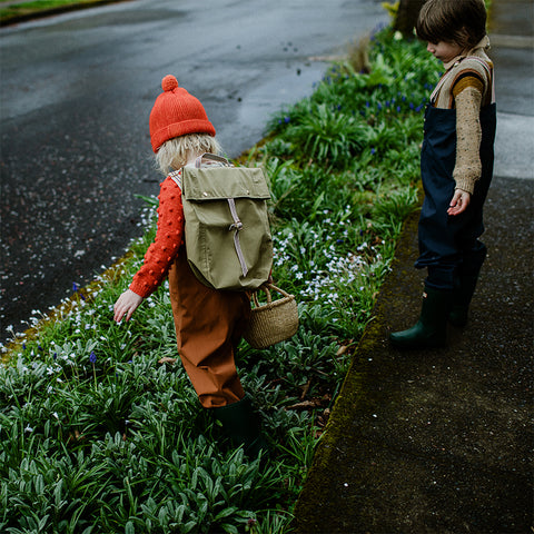 Children exploring outdoors in rain pants