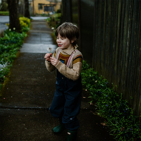 Child playing in rain pants
