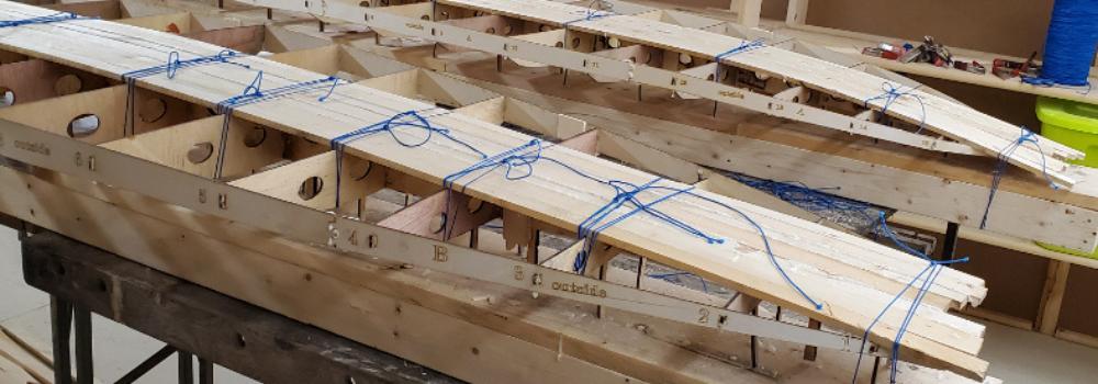 Gluing wooden strips to one side of the paddleboard