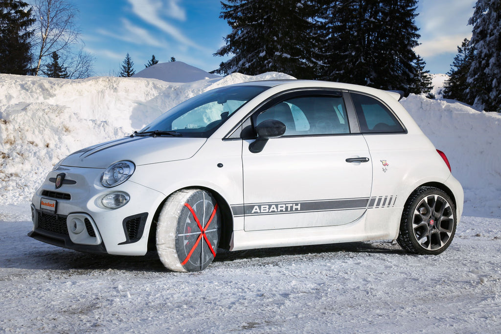 AutoSock mounted on front wheels of an Italian passenger car, standing on snow