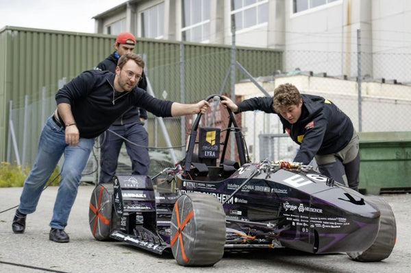 AutoSock tire cover mounted on racing car of Revolve NTNU, used as tire and rim protection