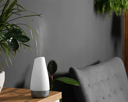an aroma diffuser near grey couch