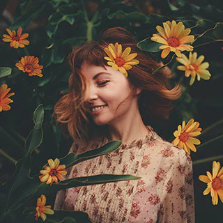 A cute girl is flipping her hair with background of sunflower plants