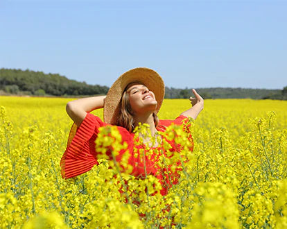 A woman is enjoying at the yellow flower farm