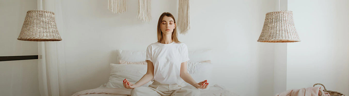 A woman is doing meditation in the bedroom