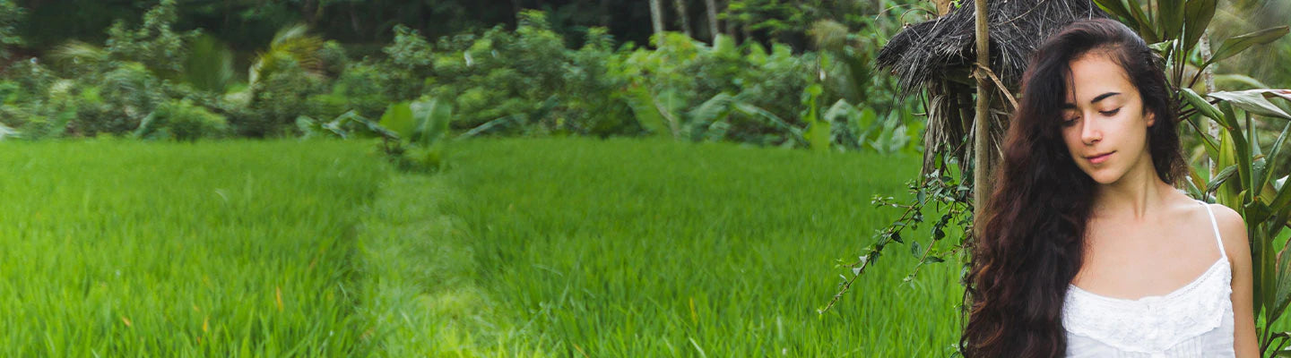 A woman is standing at the green farm