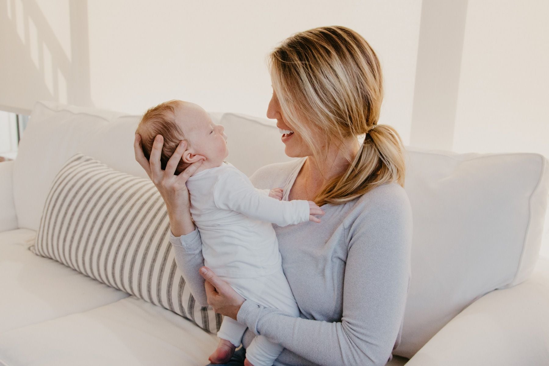 mom on couch holding baby