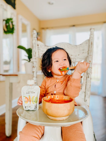Baby girl eating biodynamic baby food