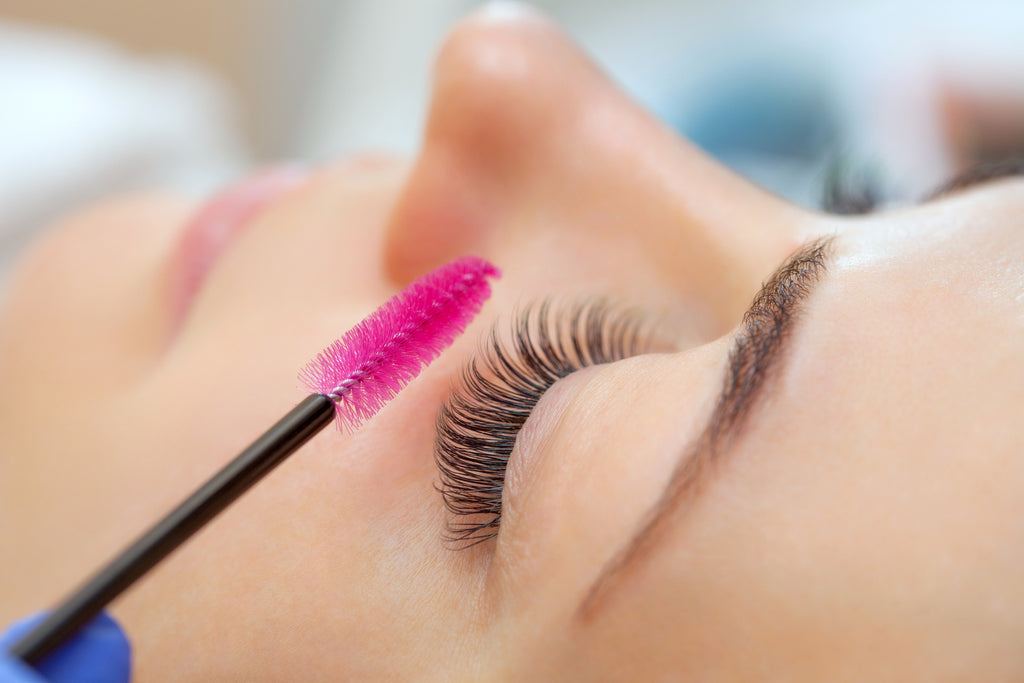 Woman getting her eyelashes cleaned with an eyelash cleaning tool