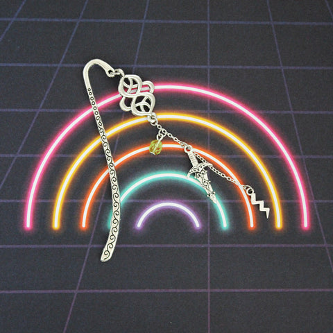 Loki silver bookmark on a rainbow background