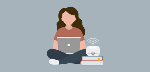 graphic of girl on computer with white noise machine next to her