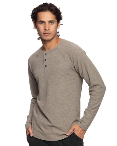 Man in a walnut, long-sleeved henley t-shirt