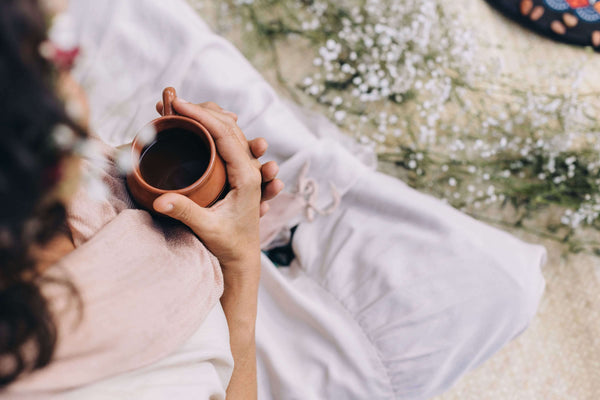 woman drinking a mug of tea