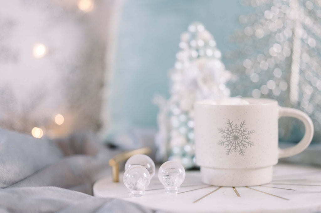 crystals for december - mug with clear quartz spheres and a christmas tree in the background