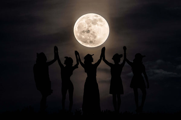 Women dancing under the moonlight