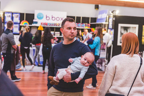 Image of father and child in front of B.Box and Baby Box stand at the Wellington Baby Expo