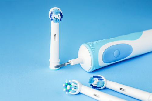 modern-electric-toothbrush-and-spare-heads-on-blue-2023-11-27-05-22-03-utc.jpg__PID:df7b0f13-40f6-4b05-9935-fcfa1bfa98b5