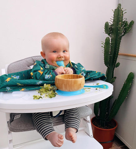 Baby sat in highchair eating