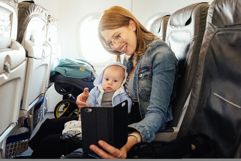 Mother, baby and Doona car seat in an airplane